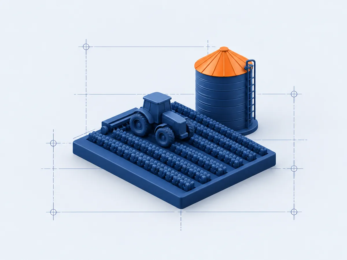 Maqueta de un tractor sobre surcos de cultivo junto a un silo con techo naranja